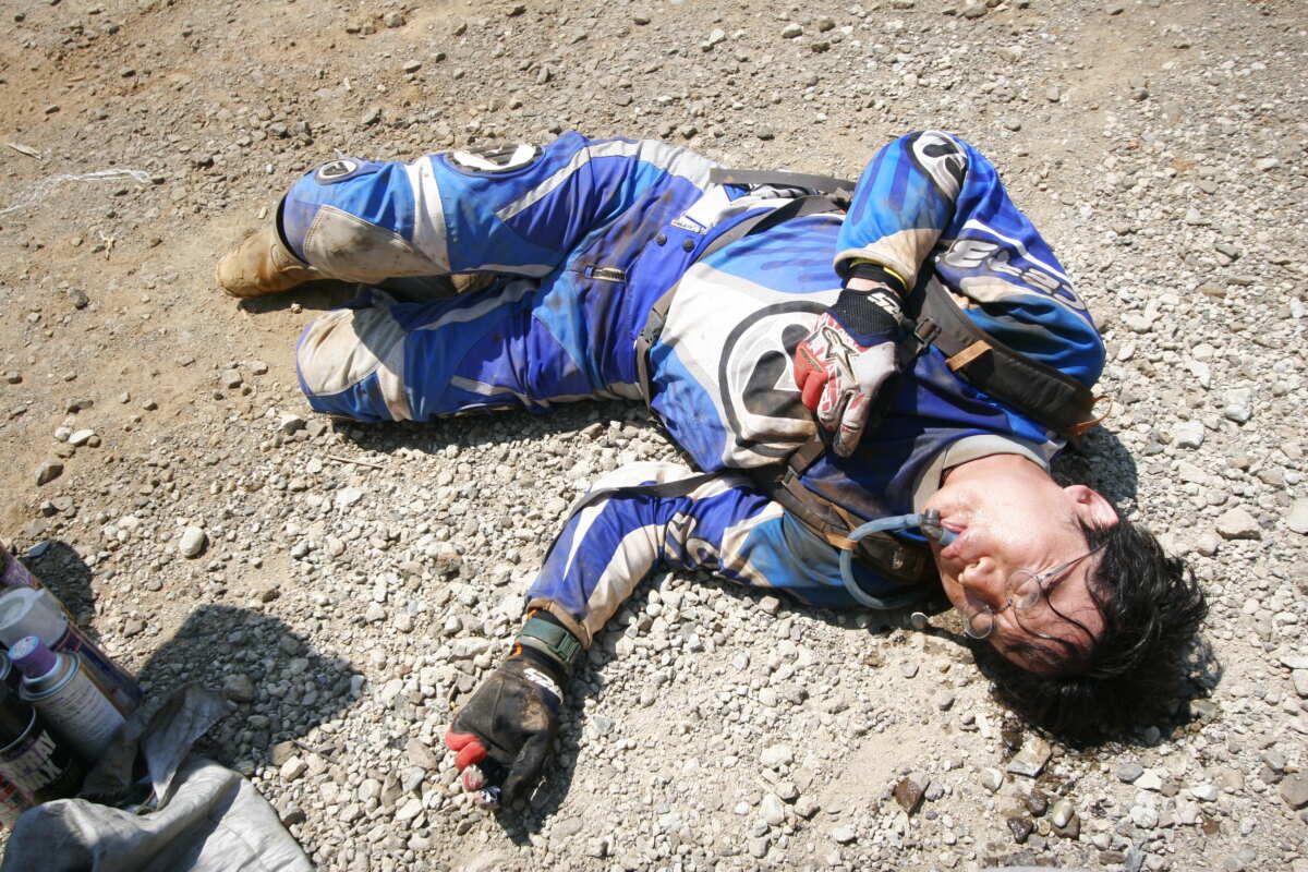 1台のバイクを３人交代で8時間を走り切るエンデューロレースに出た時の筆者。途中で水分補給するためにキャメルバックを背負って走り、心拍数は常に160を超えているような感じ。次のライダーにバイクを渡した後はこんな感じでとにかく疲労困憊。